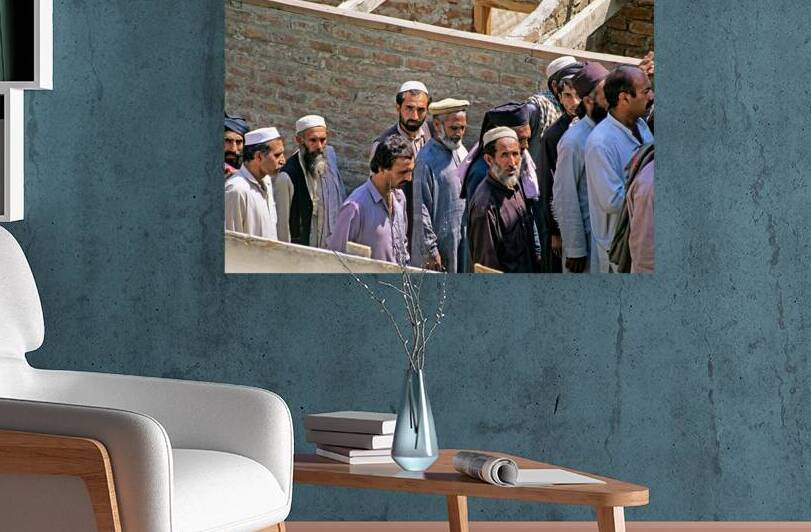 Men heading to work in Peshawar streets during morning hours by Marco Brivio