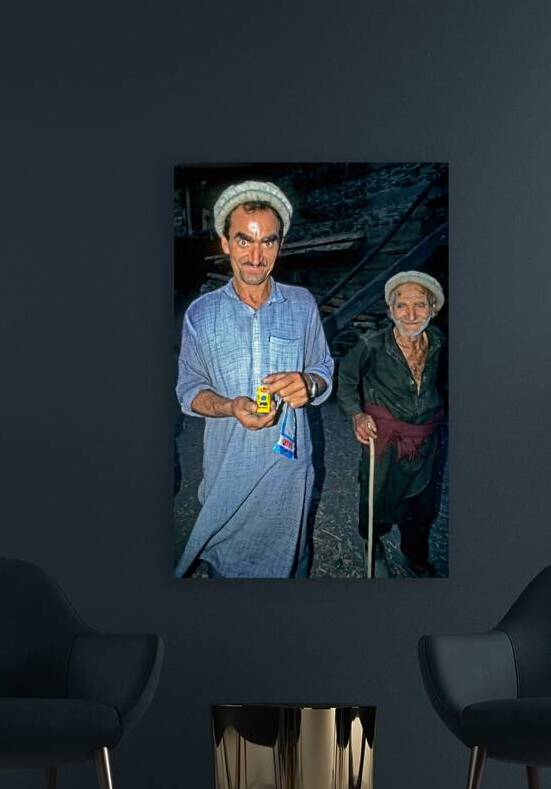 Men show toy in Kalash Village during evening hours by Marco Brivio