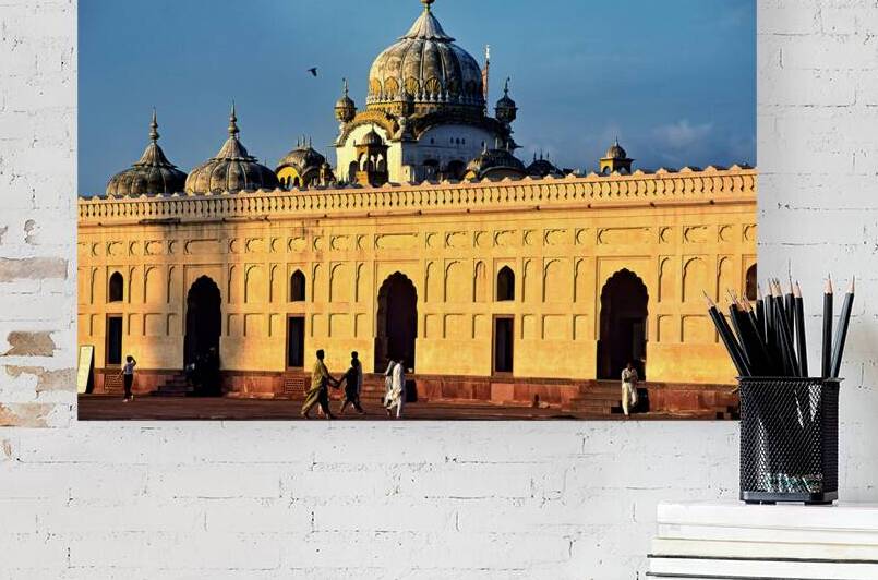 Visitors explore Badshahi Mosque in Lahore at sunset by Marco Brivio