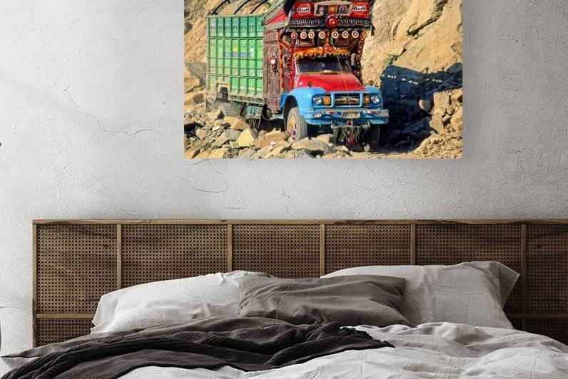 Trucks travel toward Shandur Pass in Pakistans rugged terrain by Marco Brivio