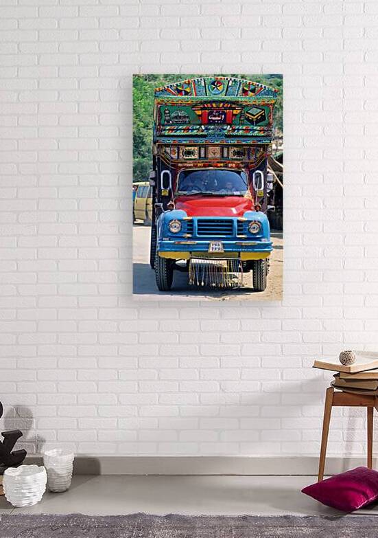 Colorful truck in Pakistan carrying local goods on the road by Marco Brivio