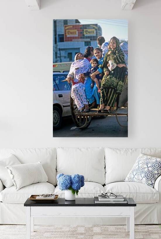 Family travels on rickshaw in busy Lahore streets by Marco Brivio