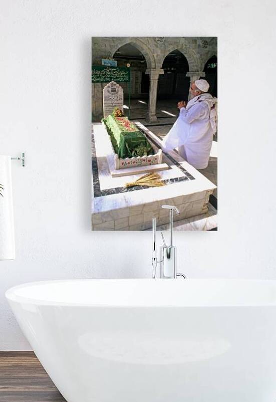 Man praying at a shrine in Pakistan during daylight hours by Marco Brivio