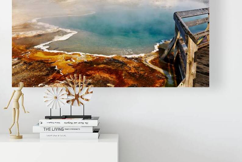 Steam rises from Abyss Pool as blue water reflects the surrounding landscape at Yellowstone National Park. Visitors explore the area nearby. by Marco Brivio