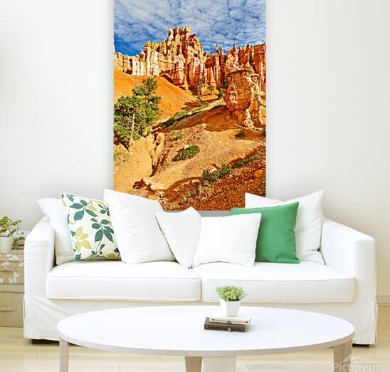 Visitors walk through Queens Garden in Bryce Canyon National Park. Tall rock formations and clouds fill the sky during daylight. by Marco Brivio