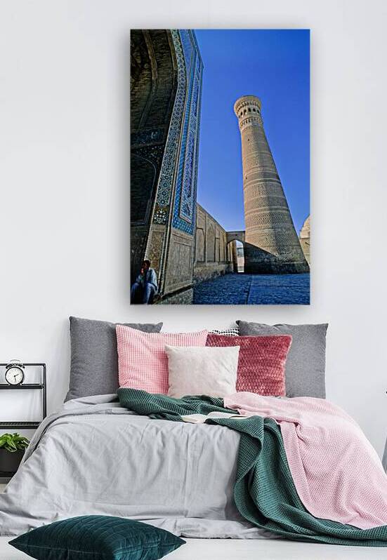 People rest near the tall minaret in Khiva Uzbekistan by Marco Brivio