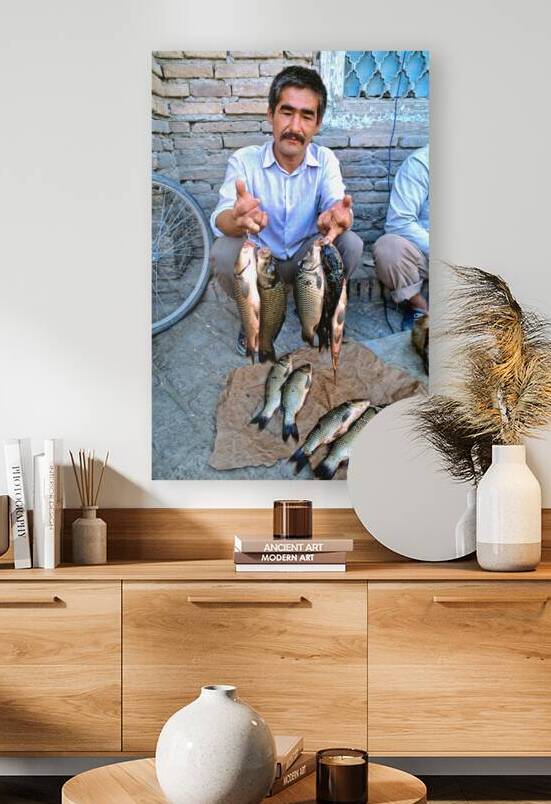 Man selling fish in Khiva Uzbekistan during the day by Marco Brivio