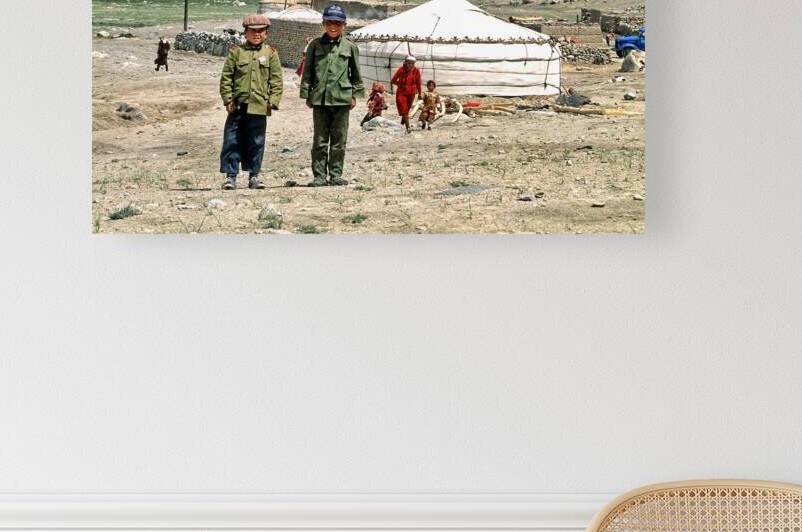 Children stand together near a yurt in an Uzbek village by Marco Brivio