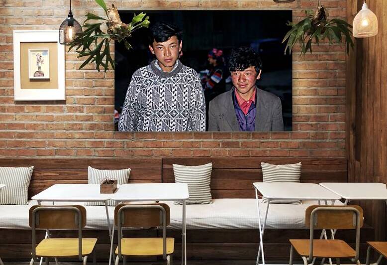 Boys stand together in Uzbekistan at night during a local event by Marco Brivio