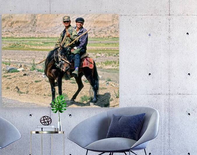 Tadjik men ride a horse in Uzbekistans landscape by Marco Brivio