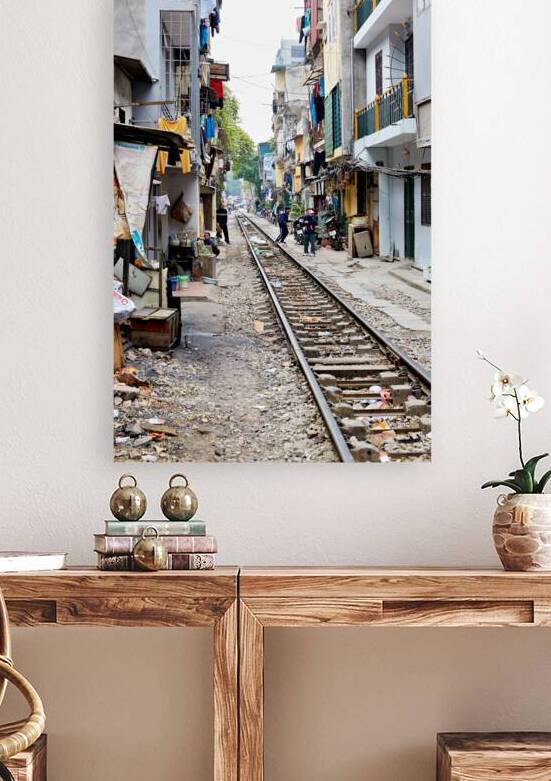 People walk along railway tracks in Ho Chi Minh City Vietnam by Marco Brivio