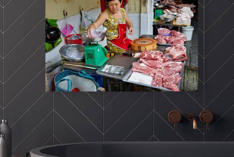 Local butcher weighs meat in Ho Chi Minh City market by Marco Brivio