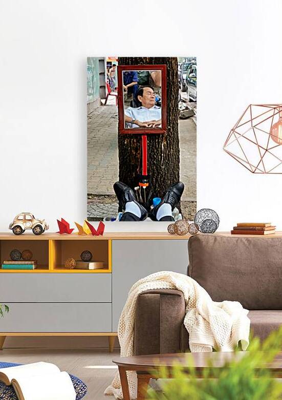 Man resting in Ho Chi Minh City with mirror reflection by Marco Brivio