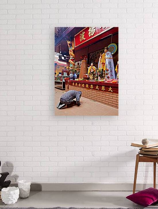 Person praying at a temple in Ho Chi Minh City Vietnam by Marco Brivio