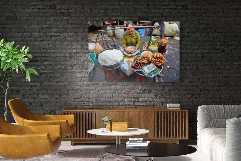 Woman selling food at street market in Ho Chi Minh City by Marco Brivio