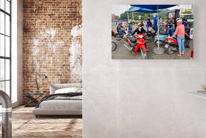 People refueling motorbikes at a gas station in Ho Chi Minh City by Marco Brivio