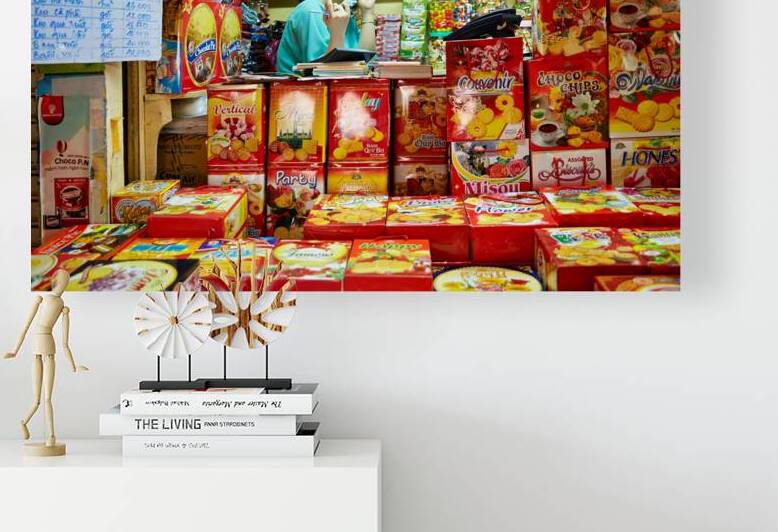 Market scene in Ho Chi Minh City with shopkeeper on phone by Marco Brivio