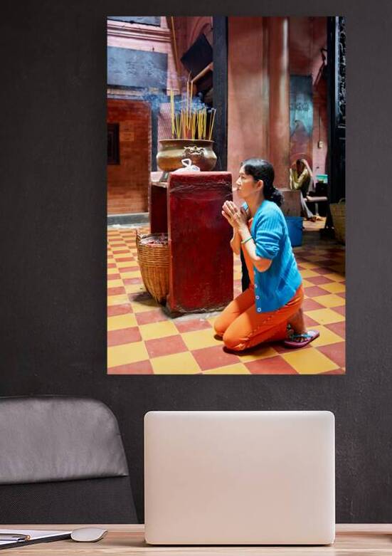 Woman prays at a temple in Ho Chi Minh City Vietnam by Marco Brivio