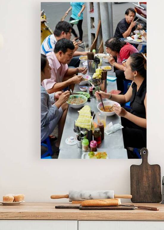 People eating at street food stalls in Ho Chi Minh City by Marco Brivio