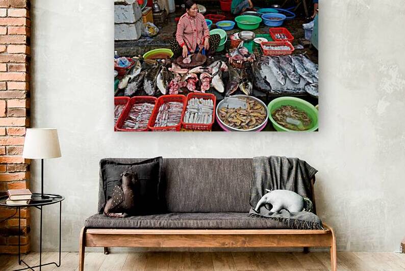 Woman sells fish at market in Phu Quoc Vietnam during daytime by Marco Brivio