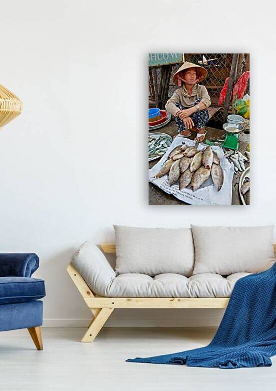 Fish seller sits by market stall in Phu Quoc Vietnam by Marco Brivio