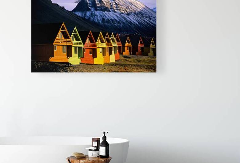 Colorful cabins in Longyearbyen Svalbard near snowy mountains by Marco Brivio