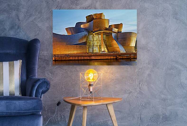 Guggenheim Museum at dusk in Bilbao Spain with lights on by Marco Brivio