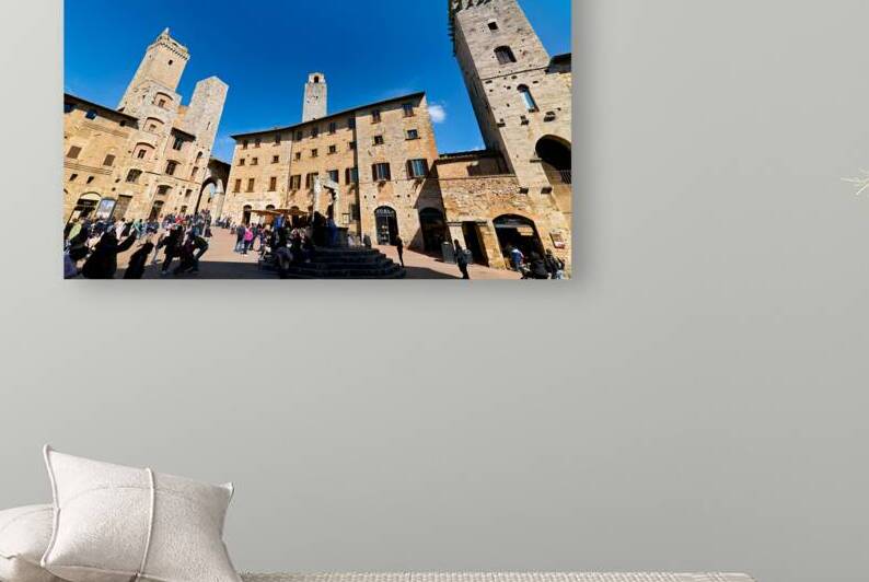 Visitors walk through Piazza della Cisterna in San Gimignano by Marco Brivio