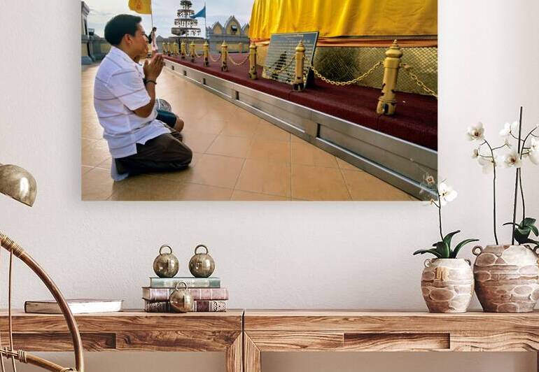 Visitor prays at Wat Saket Golden Mount in Bangkok Thailand by Marco Brivio