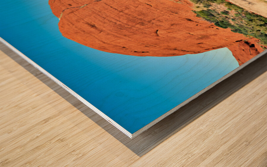 Vast red rock formation under a clear blue sky. Wood print