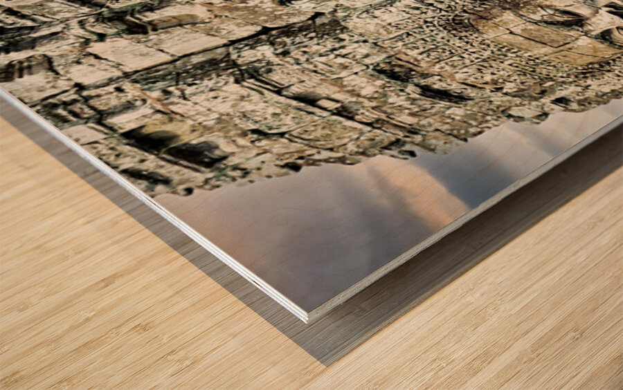 Serene stone faces adorn ancient Cambodian temple. Wood print