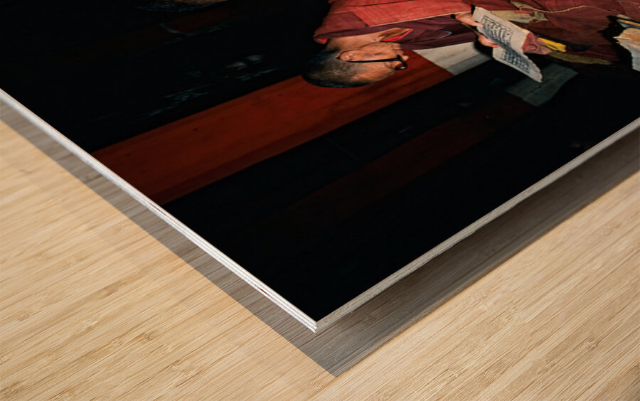 Monks read sacred texts in a Tibetan temple at night Wood print
