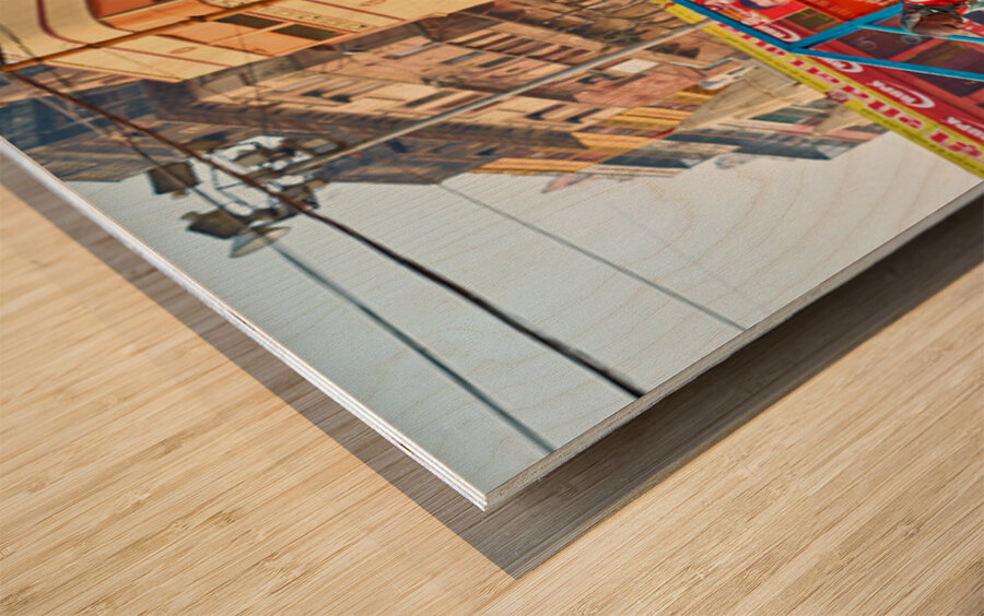 Sacred cow in Varanasi with people and shops in background Wood print