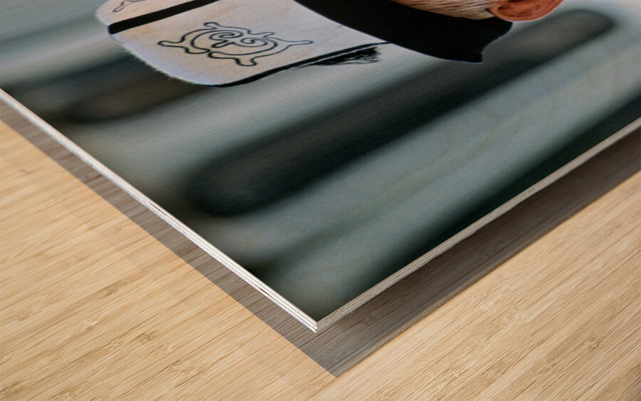 Elderly man in traditional hat walks in Bukhara Uzbekistan Wood print