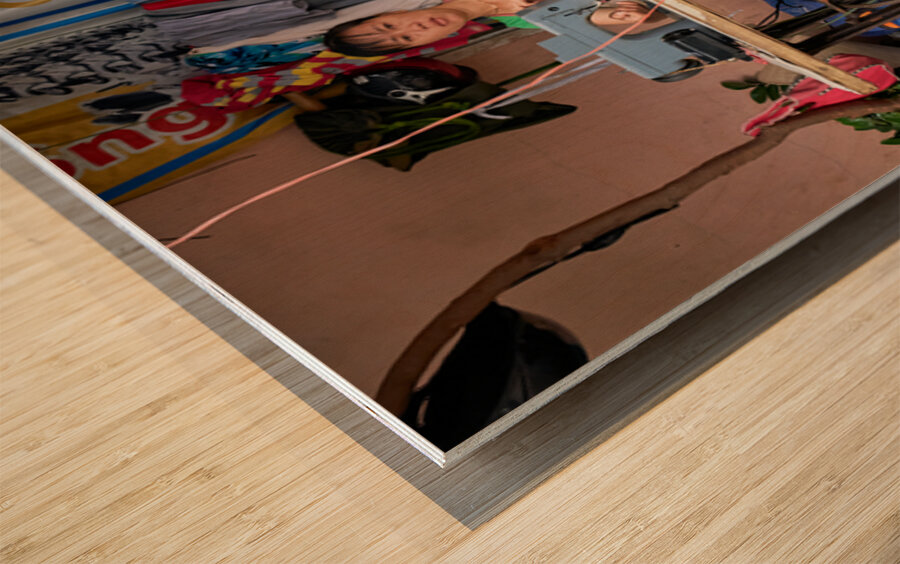 Sewing clothes at a market stall in Phu Quoc Vietnam Wood print