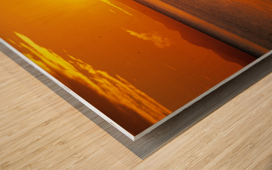 Midnight sun at Longyearbyen in Svalbard with a boat on the water Wood print