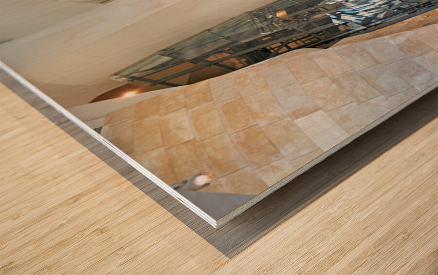 Visitors explore the interior of the Guggenheim Museum in Bilbao Wood print